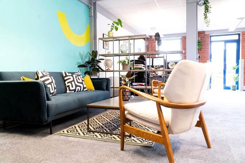 Blue and yellow interior wall graphics in a waiting area for an office space.